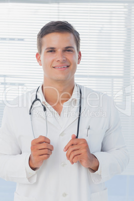 Young doctor holding his stethoscope