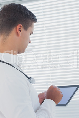 Young doctor using tablet pc