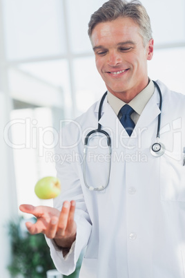 Doctor throwing an apple