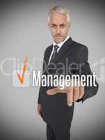 Businessman selecting the word management