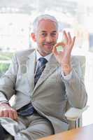Happy businessman giving ok sign