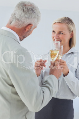 Happy business partners toasting with champagne