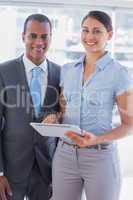 Business team with tablet pc smiling