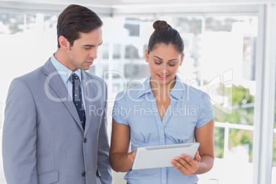 Business team looking at tablet pc