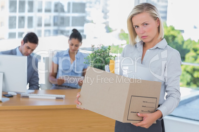 Upset businesswoman leaving office after being let go