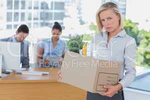 Upset businesswoman leaving office after being let go