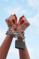 Hands tied up with chains