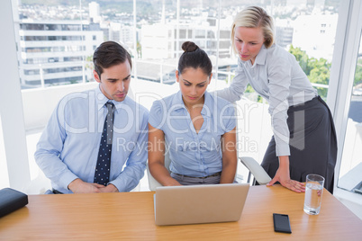 Business team looking at laptop