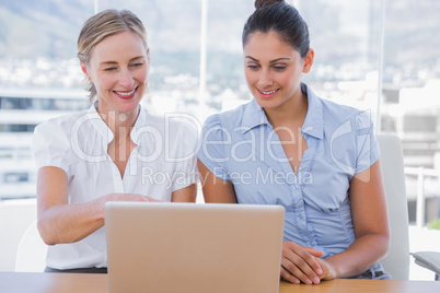 Businesswomen looking at laptop