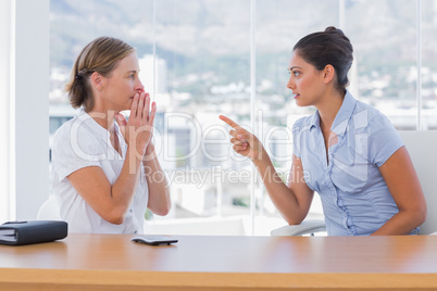 Businesswoman pointing to a colleague