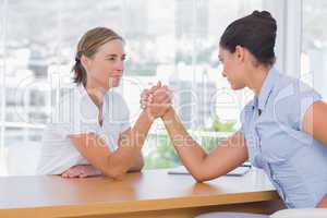 Businesswomen having an arm wrestle