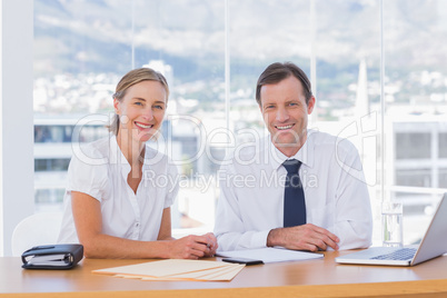 Smiling business people posing together