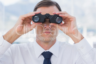 Close up of businessman using binoculars