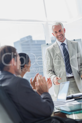 Colleagues applauding the manager during a meeting