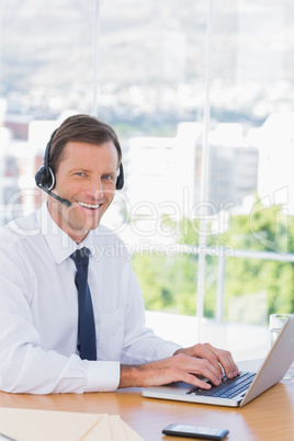 Smiling businessman wearing a headset