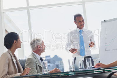 Smiling manager standing in front of colleagues