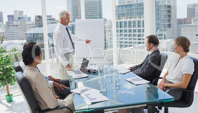 Manager pointing at a chart during a meeting