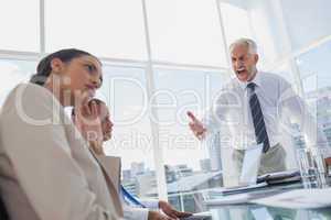 Furious boss yelling at colleagues