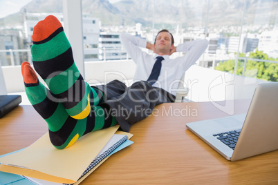 Business having a nap with feet on his desk
