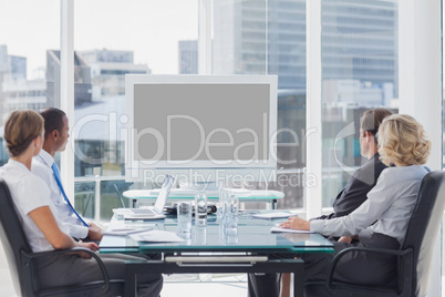 Group of business people looking at a screen