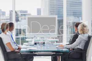 Group of business people looking at a screen