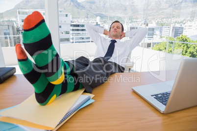 Businessman having a nap with feet on the desk