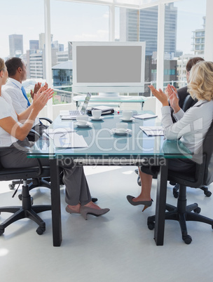 Business people applauding during a video conference