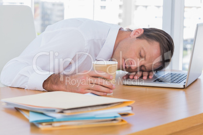 Businessman sleeping on a laptop