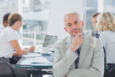 Smiling businessman posing in the boardroom