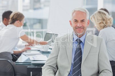 Charismatic businessman posing in the boardroom