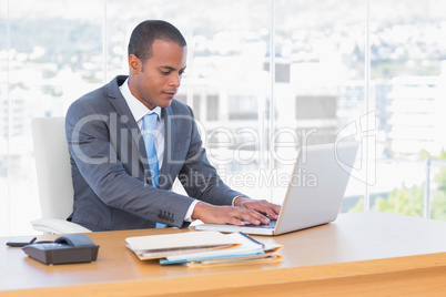 Handsome businessman working at his laptop