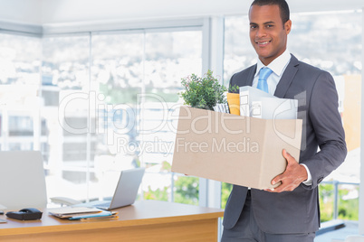 Smiling businessman leaving his company