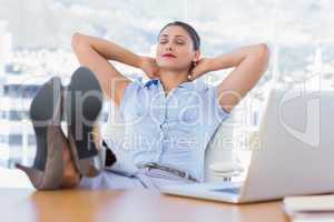 Attractive businesswoman relaxing in her office