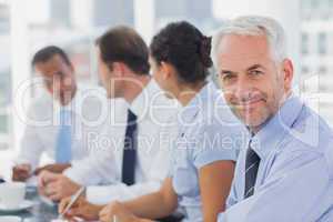 Smiling businessman posing in the meeting room