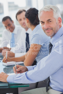 Cheerful businessman posing in the meeting room