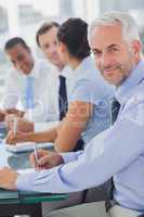 Cheerful businessman posing in the meeting room