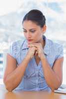 Sad businesswoman sitting at her desk