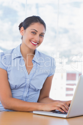 Pretty businesswoman working on her laptop