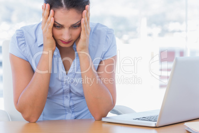 Stressed businesswoman having her head in hands