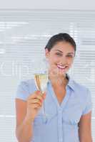 Attractive businesswoman holding champagne