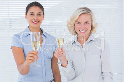 Attractive businesswomen drinking champagne