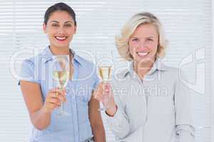 Attractive businesswomen drinking champagne