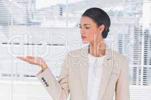 Attractive businesswoman opening her hand