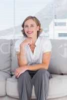 Confident businesswoman sitting on couch