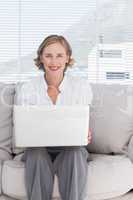 Portait of a smiling businesswoman using a laptop