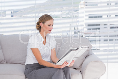 Businesswoman reading newspaper