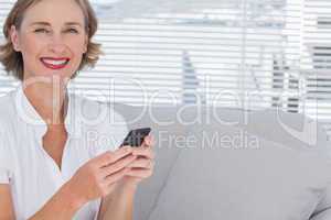 Smiling businesswoman using her mobile phone