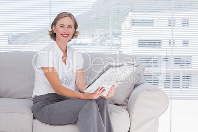 Businesswoman holding newspaper