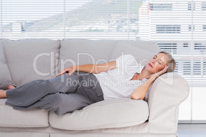 Businesswoman lying on couch