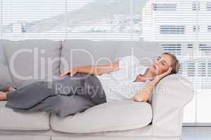 Businesswoman lying on couch